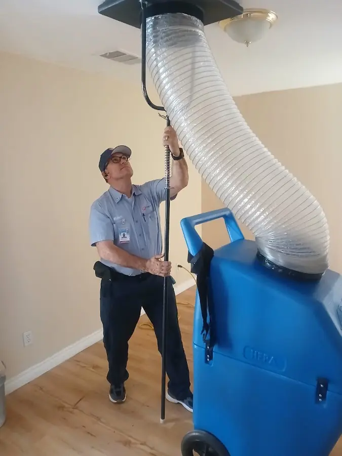 Furnace Tune-Up technician using HEPA equipment in West Sacramento